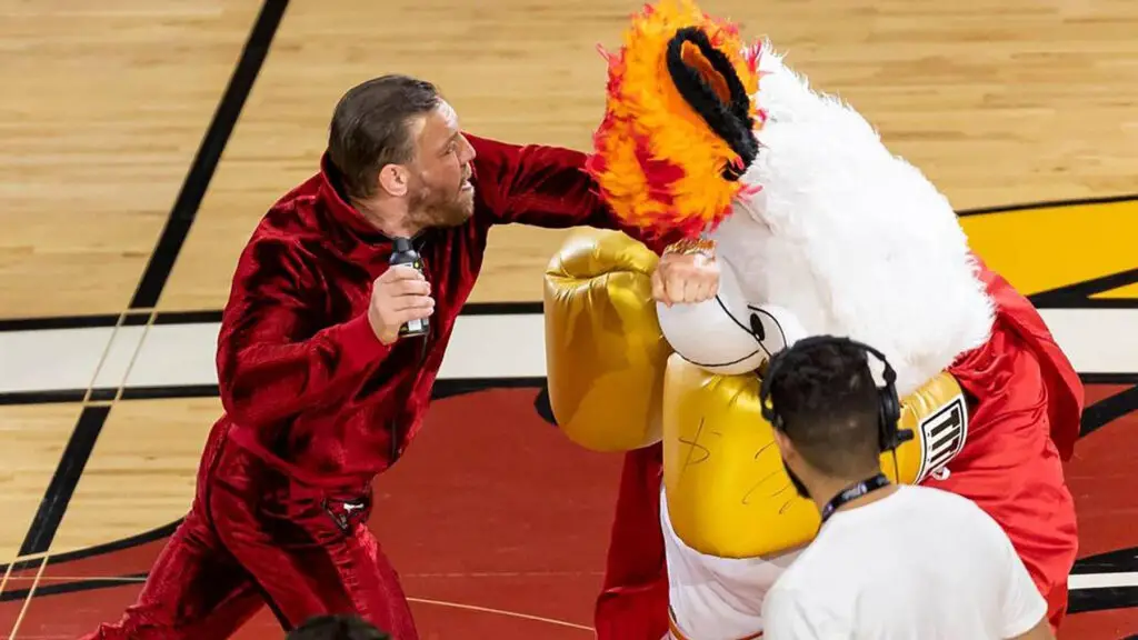 Mixed martial arts fighter Conor McGregor swings at Miami Heat mascot Burnie during a timeout period in Game 4 of the NBA Finals against the Denver Nuggets