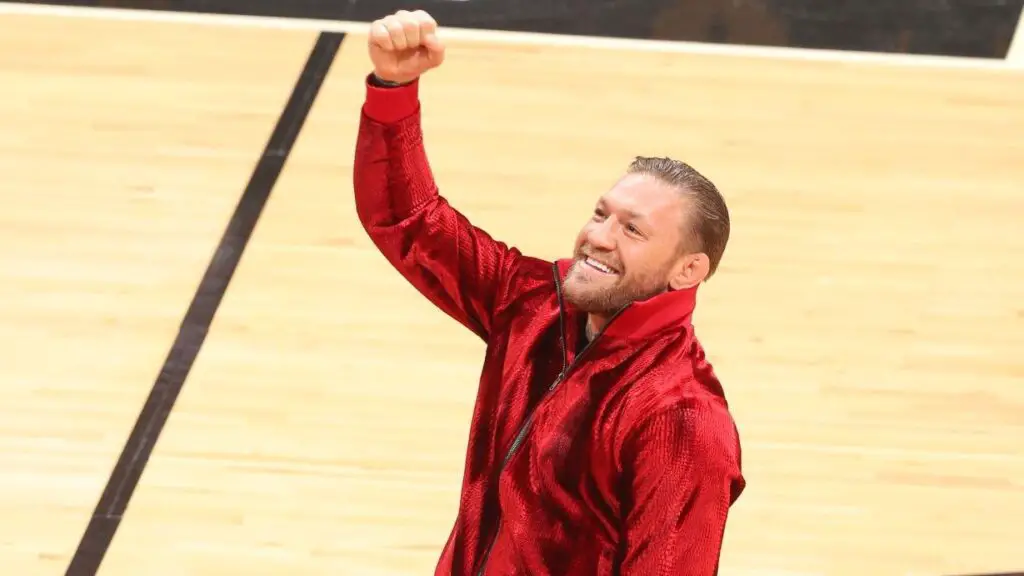 UFC Superstar Conor McGregor raises his fist into the air after a half court appearance during Game 4 of the 2023 NBA Finals