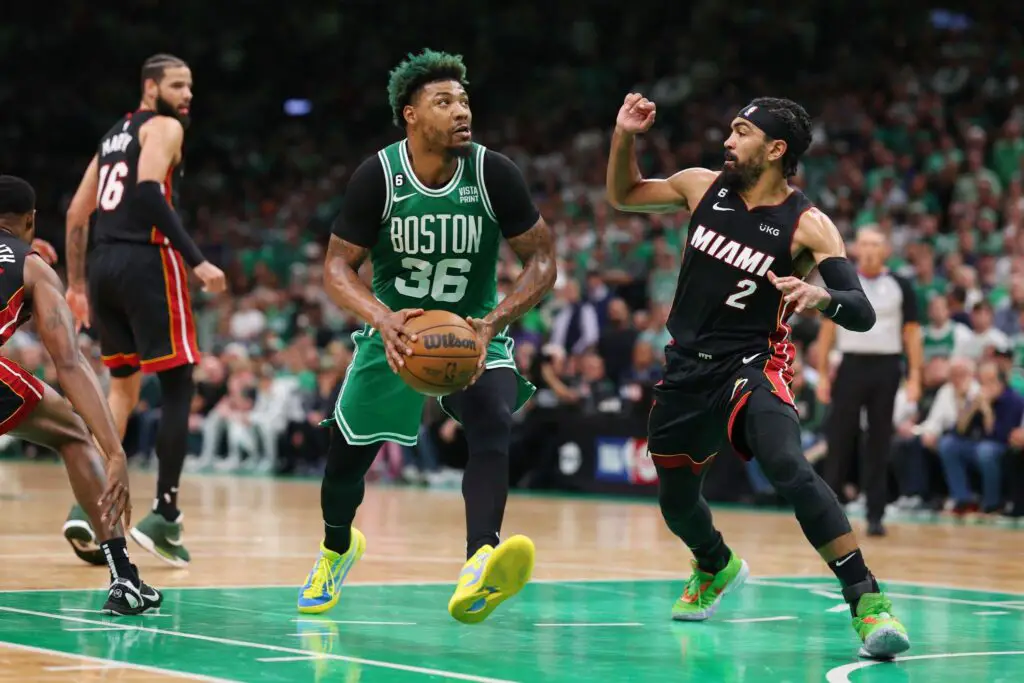 Former Boston Celtics guard Marcus Smart dribbles the ball against Gabe Vincent against the Miami Heat during the second quarter in Game 7 of the Eastern Conference Finals