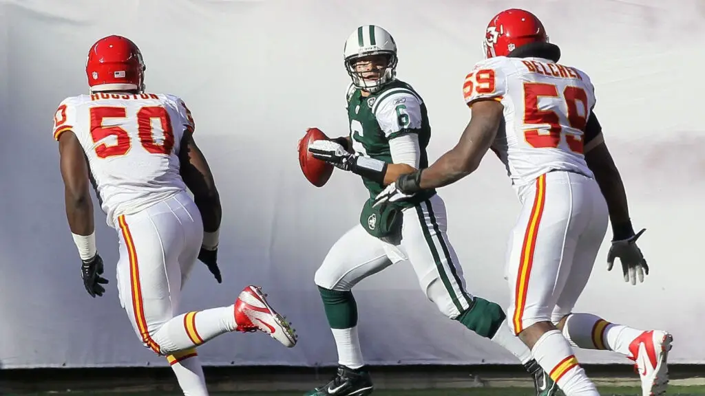 Kansas City Chiefs linebacker Jovan Belcher and teammate Justin Houston attempt to tackle New York Jets quarterback Mark Sanchez