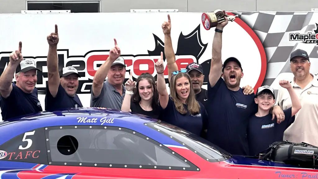 Moduline-sponsored Top Alcohol Funny Car driver Matt Gill and his team celebrate their win at the Maple Grove Divisional at Maple Grove Raceway