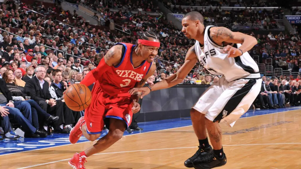Former NBA player Allen Iverson drives with the ball against George Hill against the San Antonio Spurs during the game