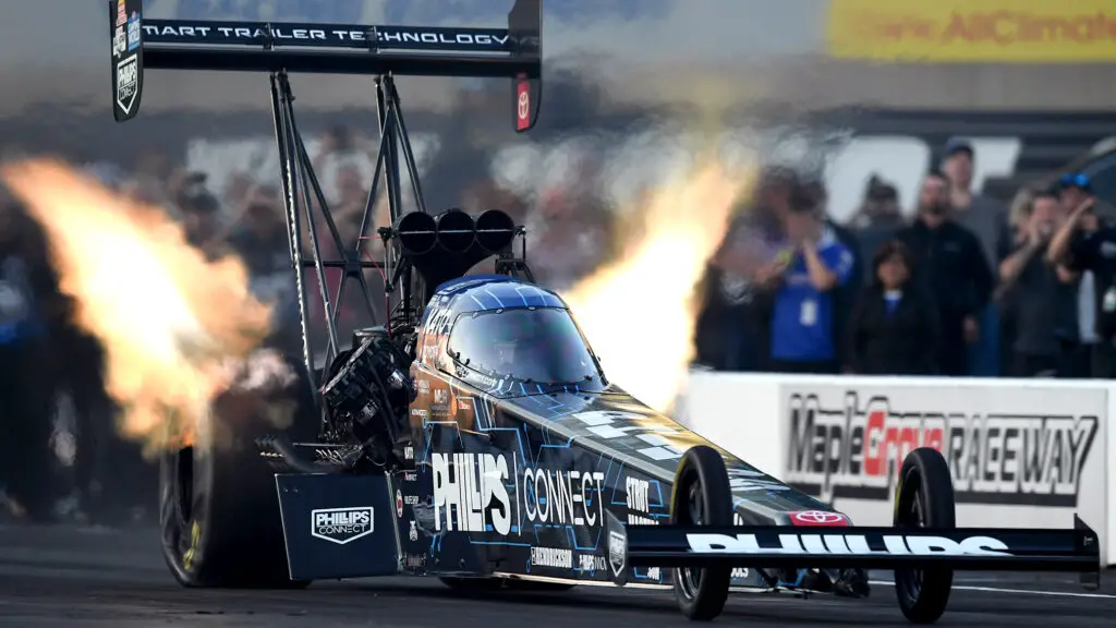 Phillips Connect Top Fuel Dragster driver Justin Ashley lights the candles during his pass at Maple Grove Raceway