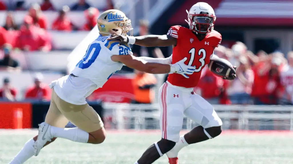 Utah Utes quarterback Nate Johnson is being chased by UCLA Bruins defensive player Kain Medrano during the first half of their game