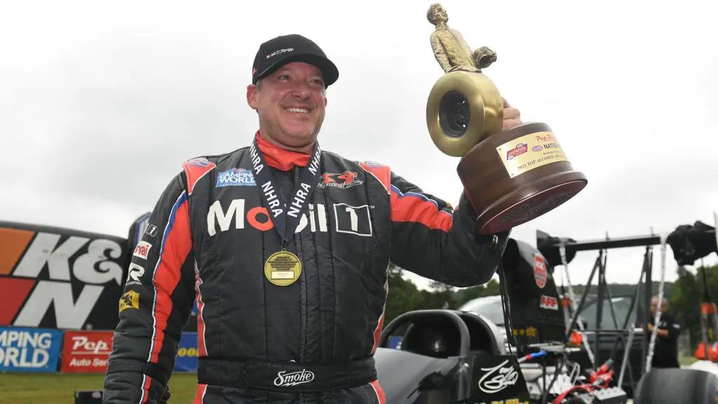 Mobil 1 Top Alcohol Dragster driver Tony Stewart celebrates his win at the Pep Boys NHRA Nationals
