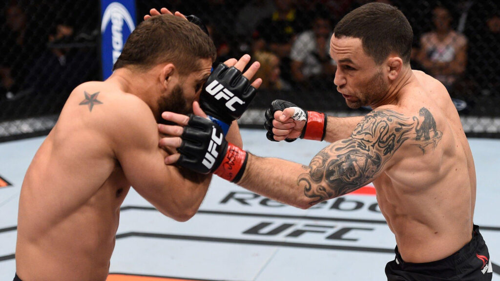 UFC fighter Frankie Edgar punches Chad Mendes in their featherweight bout during the TUF Finale event