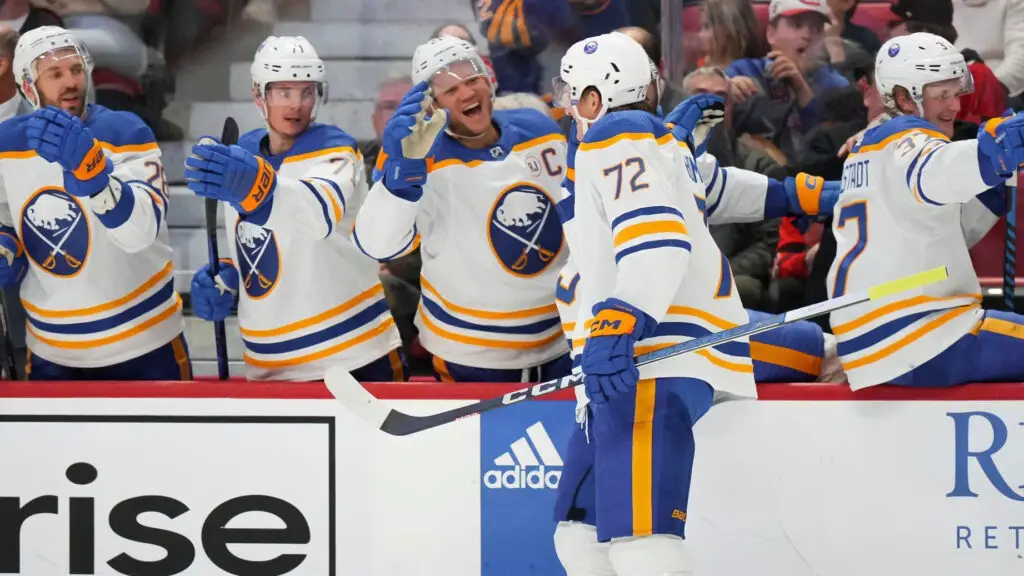 Buffalo Sabres player Tage Thompson celebrates his second-period goal against the Ottawa Senators with teammates at the players' bench