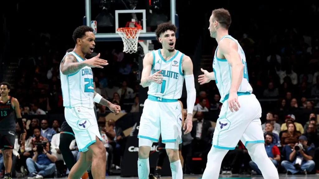 Charlotte Hornets players P.J. Washington, LaMelo Ball, and Gordon Hayward high five during the game against the Washington Wizards during the In-Season Tournament