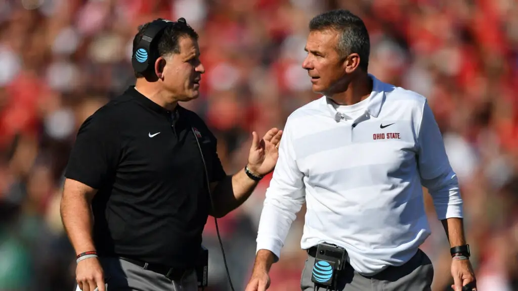 Ohio State Buckeyes Associate Head Coach and Defensive Coordinator Greg Schiano speaks with Head Coach Urban Meyer during a timeout in the first quarter against the Indiana Hoosiers