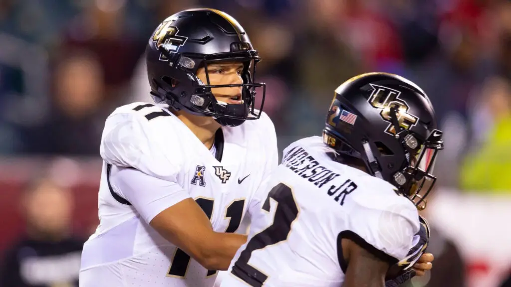 UCF Knights quarterback Dillon Gabriel hands the ball off to Otis Anderson against the Temple Owls