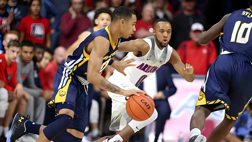 Northern Colorado player Jordan Davis is defended by Arizona Wildcats player Parker Jackson-Cartwright during the first half of the NCAA college basketball game 