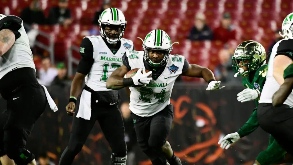 Marshall Thundering Herd running back Keion Davis takes a handoff from Isaiah Green in the third quarter against the South Florida Bulls in the Gasparilla Bowl