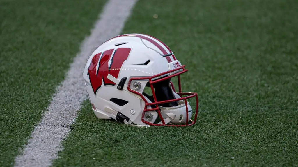 A Wisconsin Badger football helmet sits on the field during warmups before a college football game between the Penn State Nittany Lions and the Wisconsin Badgers
