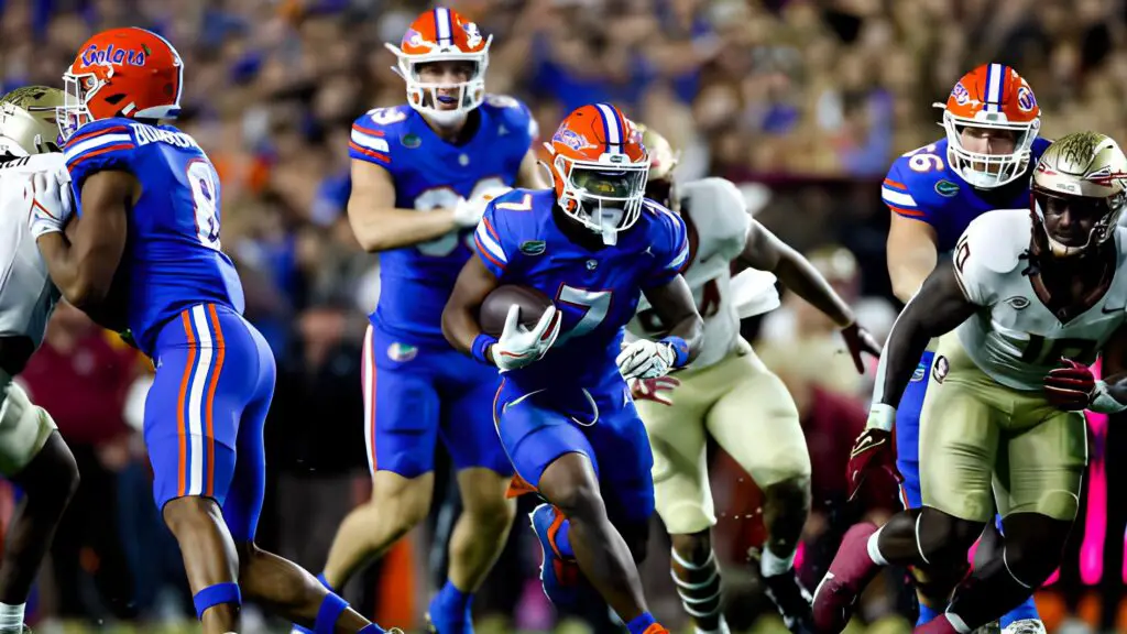 Former Florida Gators running back Trevor Etienne runs the ball during the first half of a game against the Florida State Seminoles