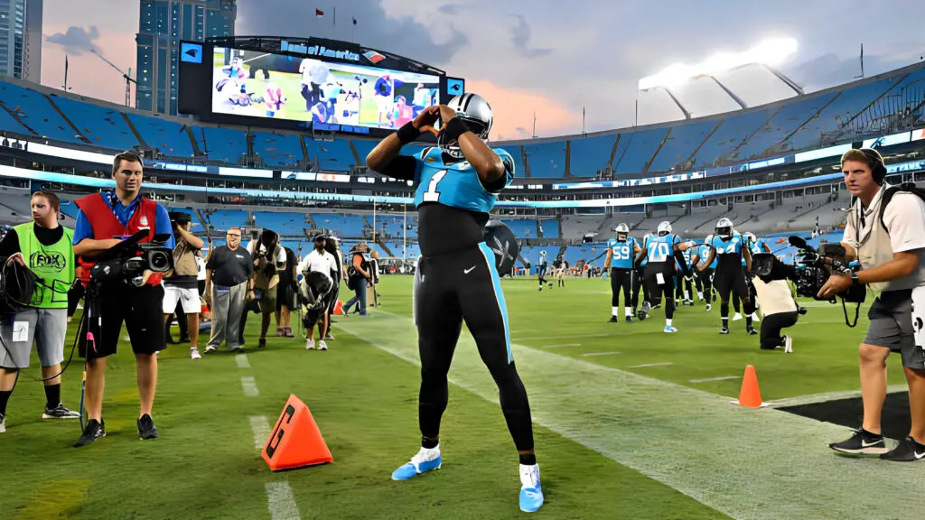 Former Carolina Panthers quarterback Cam Newton gives a heart signal to the fans during the first quarter of their game against the Tampa Bay Buccaneers