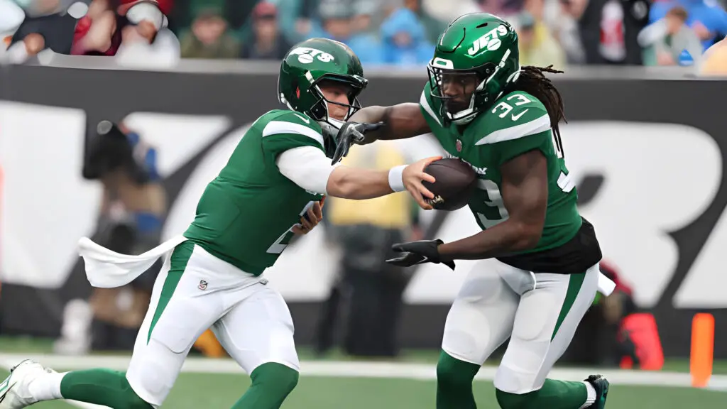 Former New York Jets running back Dalvin Cook receives the handoff from Zach Wilson against the Houston Texans during their game