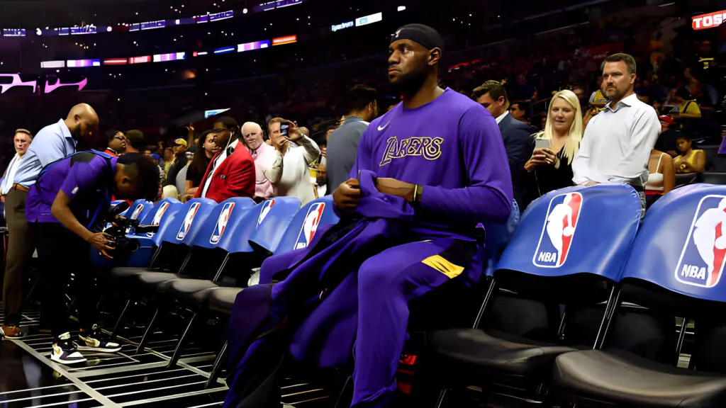Los Angeles Lakers star LeBron James sits during warm ups before the game against the Los Angeles Clippers in the Clippers home opener 