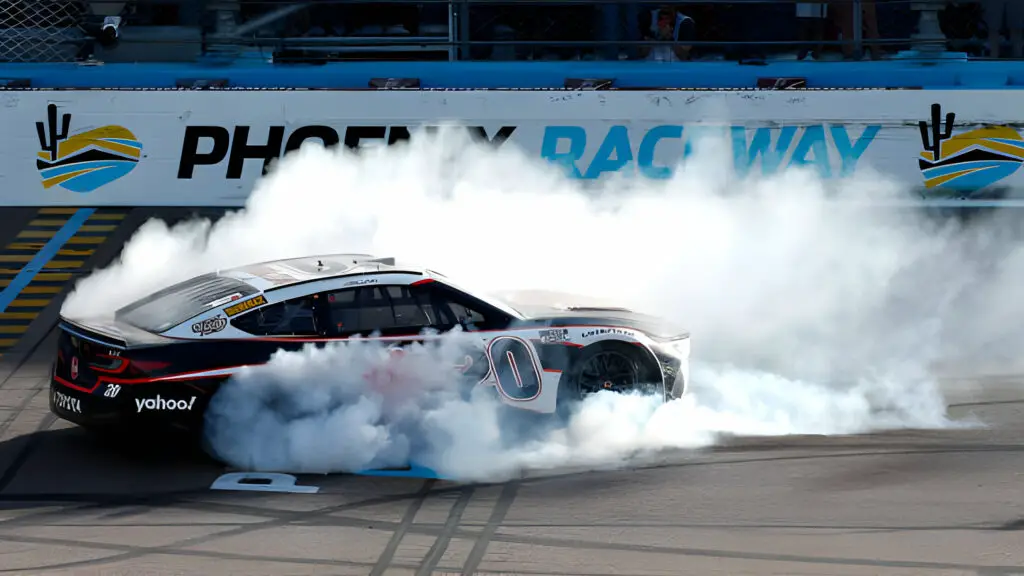 NASCAR Cup Series driver Christopher Bell celebrates with a burnout after winning the Shriners Children's 500