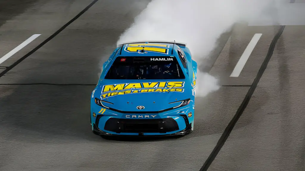 Joe Gibbs Racing driver Denny Hamlin celebrates with a burnout after winning the NASCAR Cup Series Toyota Owners 400