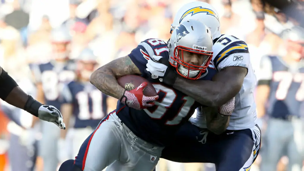 New England Patriots tight end Aaron Hernandez is tackled by San Diego Chargers linebacker Takeo Spikes during their game