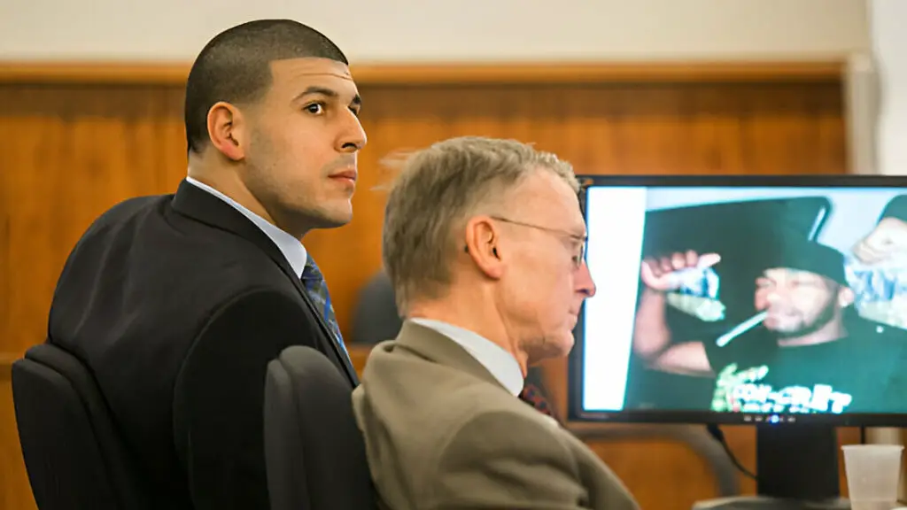Former NFL player Aaron Hernandez listens to testimony next to his attorney Charles Rankin as a photo of witness Darryl Hodge is displayed during the murder trial of Odin Lloyd