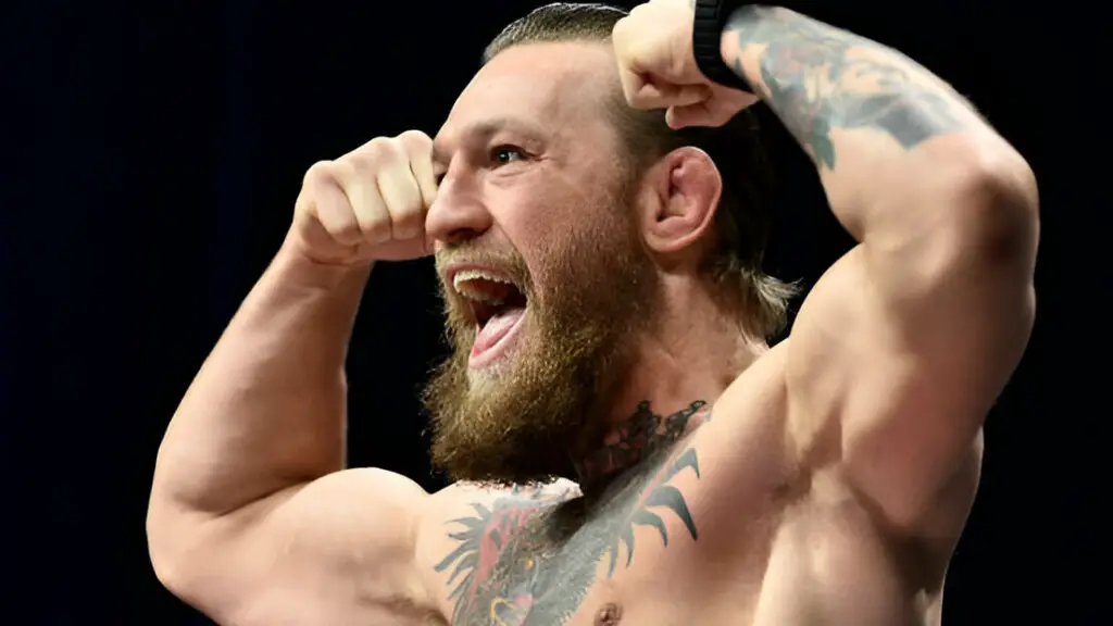 UFC star Conor McGregor poses on the scale during the UFC 246 weigh-in