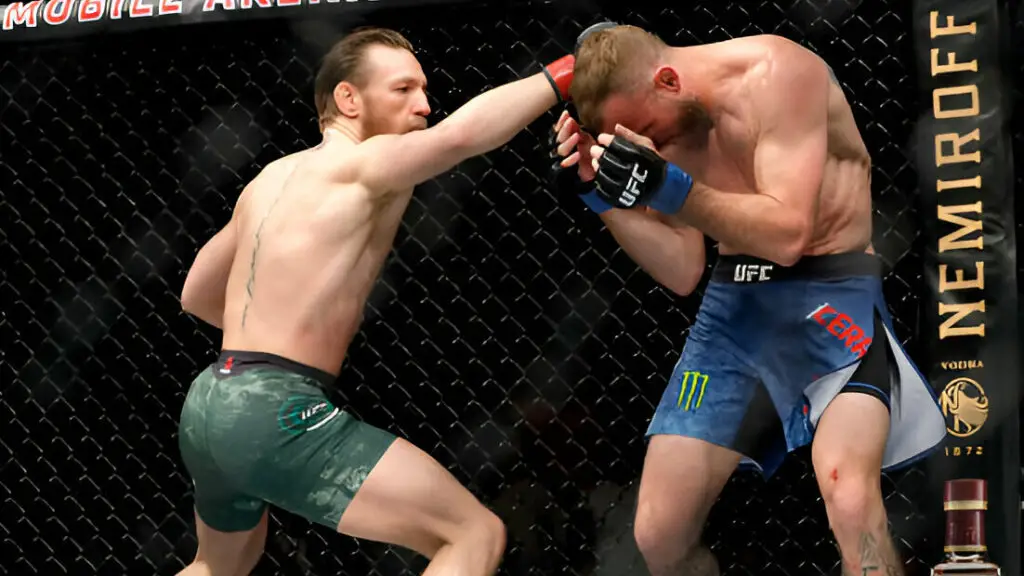 UFC star Conor McGregor throws a right punch against Donald Cerrone in the first round of their welterweight bout during UFC 246