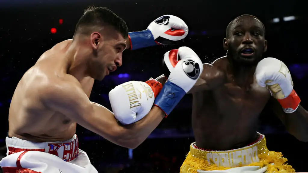 Boxer Terence Crawford punches Amir Khan during their WBO welterweight title fight