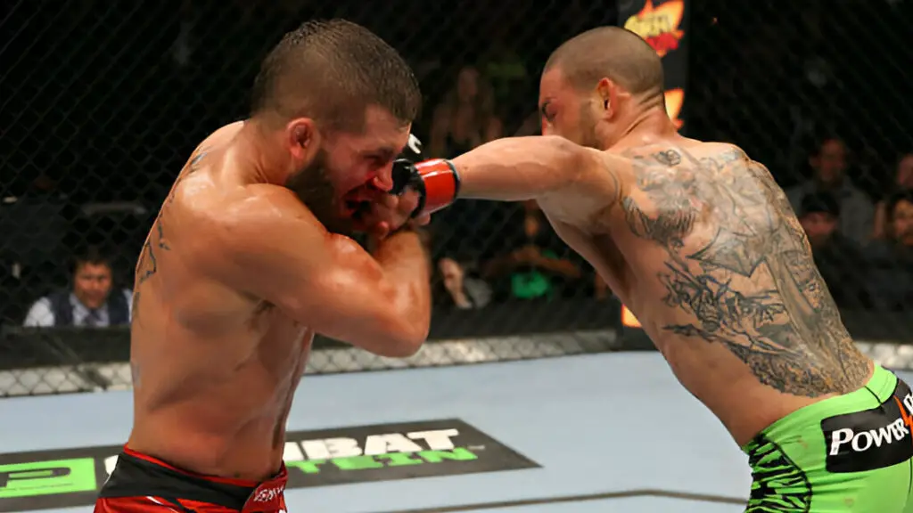 UFC fighter Cub Swanson punches Jeremy Stephens in their featherweight bout