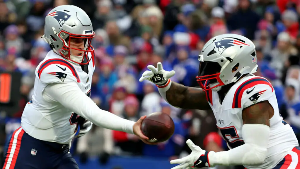 New England Patriots running back Ezekiel Elliott receives a handoff from quarterback Bailey Zappe against the Buffalo Bills