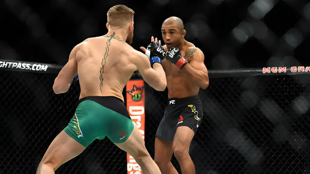 UFC fighter Conor McGregor squares off with Jose Aldo in their featherweight championship bout during the UFC 194 event