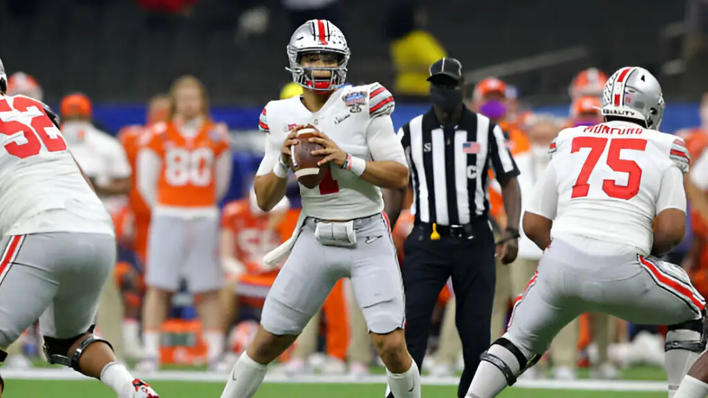 Ohio State Buckeyes quarterback Justin Fields looks to pass against the Clemson Tigers in the first half during the College Football Playoff semifinal game at the Allstate Sugar Bowl
