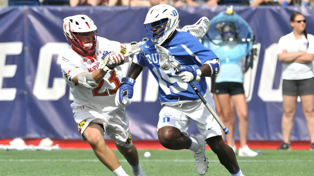 Duke player Nakeie Montgomery tries to get past Maryland defensive player Adam DiMillo as he attempts to make a play during the NCAA Lacrosse Championships Semifinal 