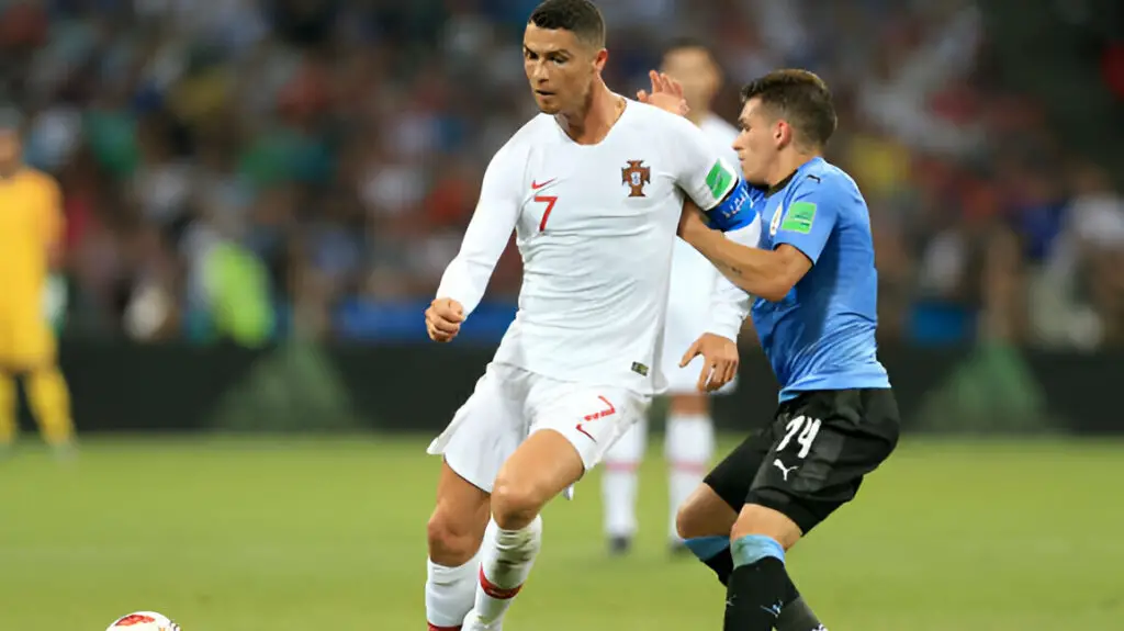 Soccer star Cristiano Ronaldo battles with Lucas Torreira during the 2018 FIFA World Cup Russia Round of 16 match between Uruguay and Portugal 