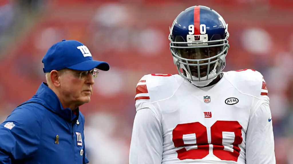 New York Giants head coach Tom Coughlin talks to defensive end Jason Pierre-Paul before the game against the Tampa Bay Buccaneers