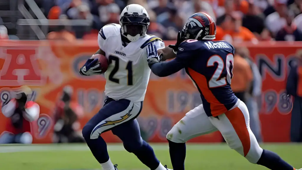 San Diego Chargers running back LaDainian Tomlinson tries to elude the tackle of Marlon McCree against the Denver Broncos during NFL action