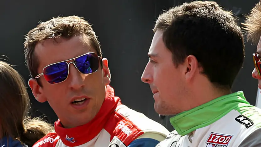 IndyCar driver Justin Wilson talks to his brother Stefan Wilson before the start of the Grand Prix of Baltimore