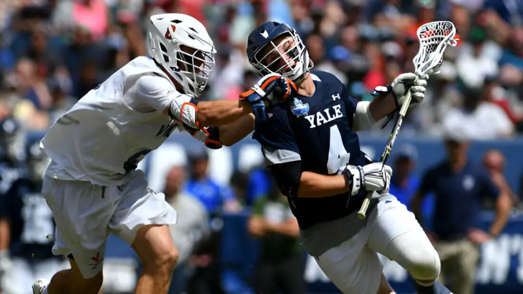 Yale Bulldogs player John Daniggelis is checked by Virginia Cavaliers player Cory Harris during the Division I Men's Lacrosse Championship