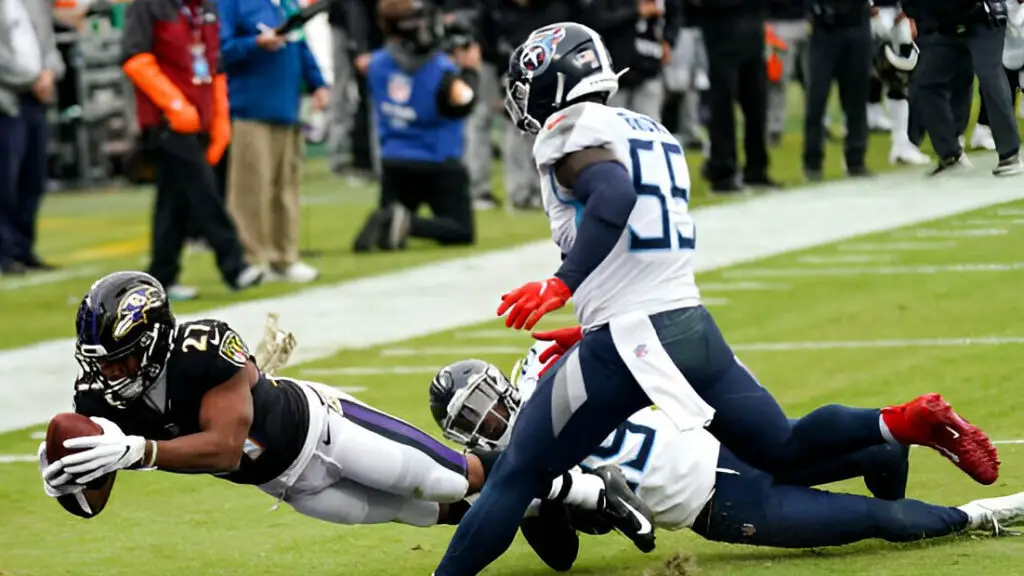 Baltimore Ravens running back J.K. Dobbins dives into the end zone for a touchdown during a game between the Tennessee Titans and the Baltimore Ravens