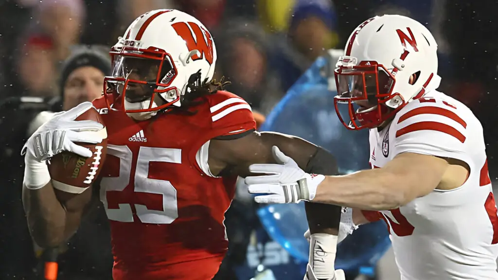 Wisconsin Badgers running back Melvin Gordon runs with the ball against as Nate Gerry tries to tackle him against the Nebraska Cornhuskers