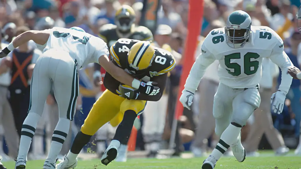 Green Bay Packers wide receiver Sterling Sharpe runs and avoids a tackle by the Philadelphia Eagles defensive players during a game