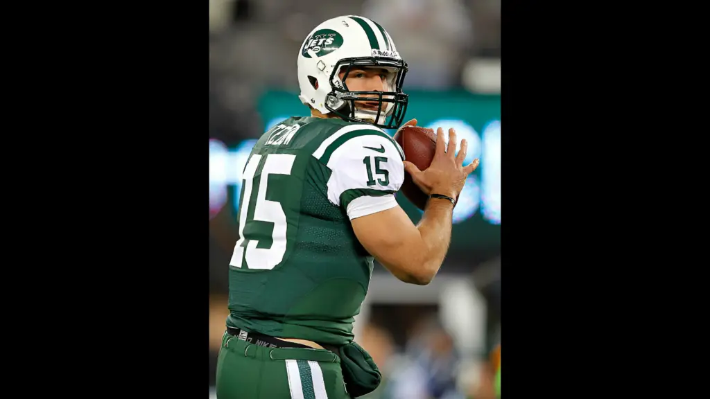 New York Jets quarterback Tim Tebow looks to pass during warm ups before the start of their game against the New England Patriots