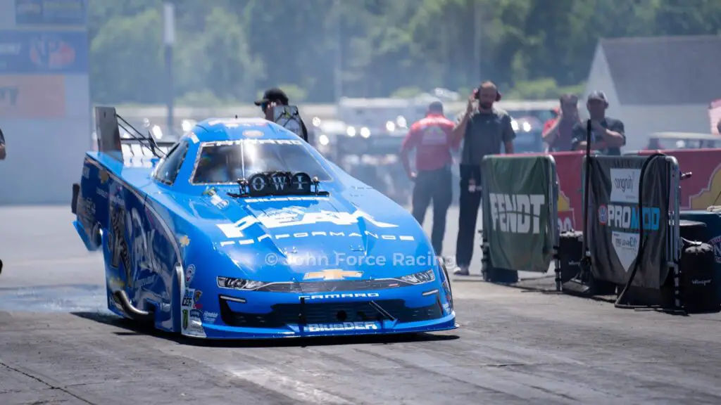 NHRA living legend John Force prepares to do a burnout before making a pass down the track