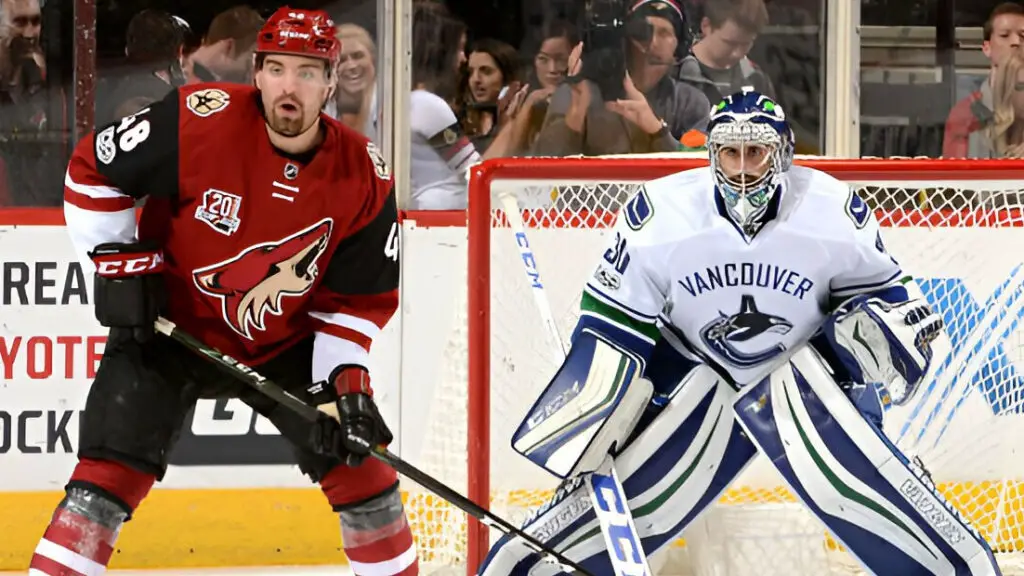 Arizona Coyotes player Jordan Martinook looks for the puck as Vancouver Canucks goalie Ryan Miller gets ready to make a save