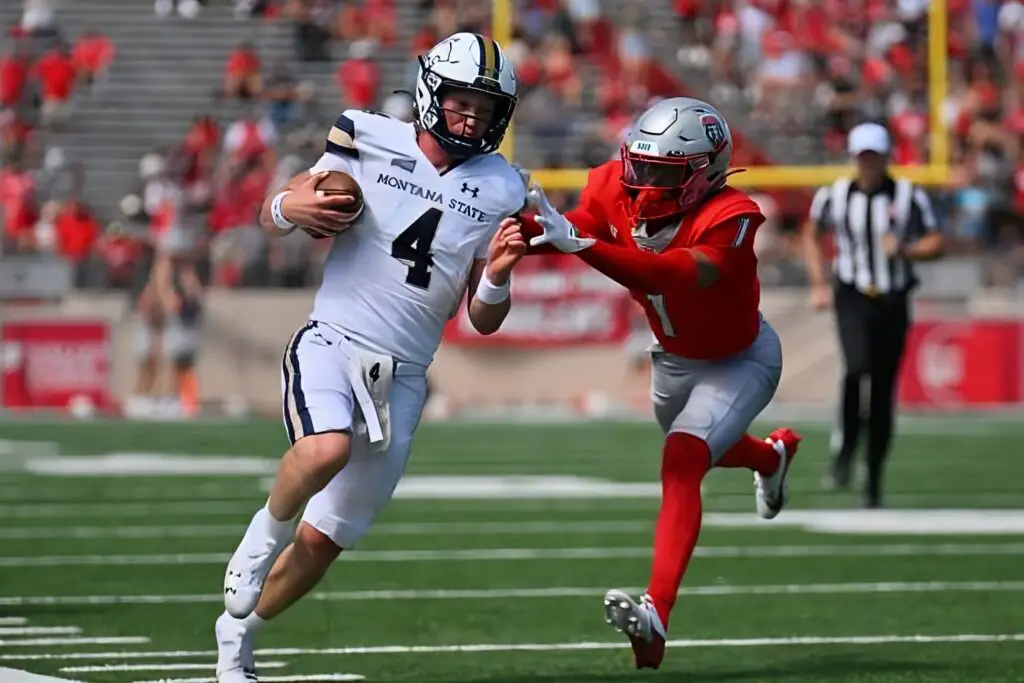 Montana State quarterback Tommy Mellott runs with the football for yardage as Noah Avinger tries to tackle him against the New Mexico Lobos during the first half of their game