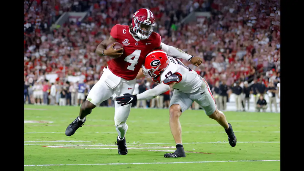 Alabama quarterback Jalen Milroe is hit by Dan Jackson against the Georgia Bulldogs during the first quarter