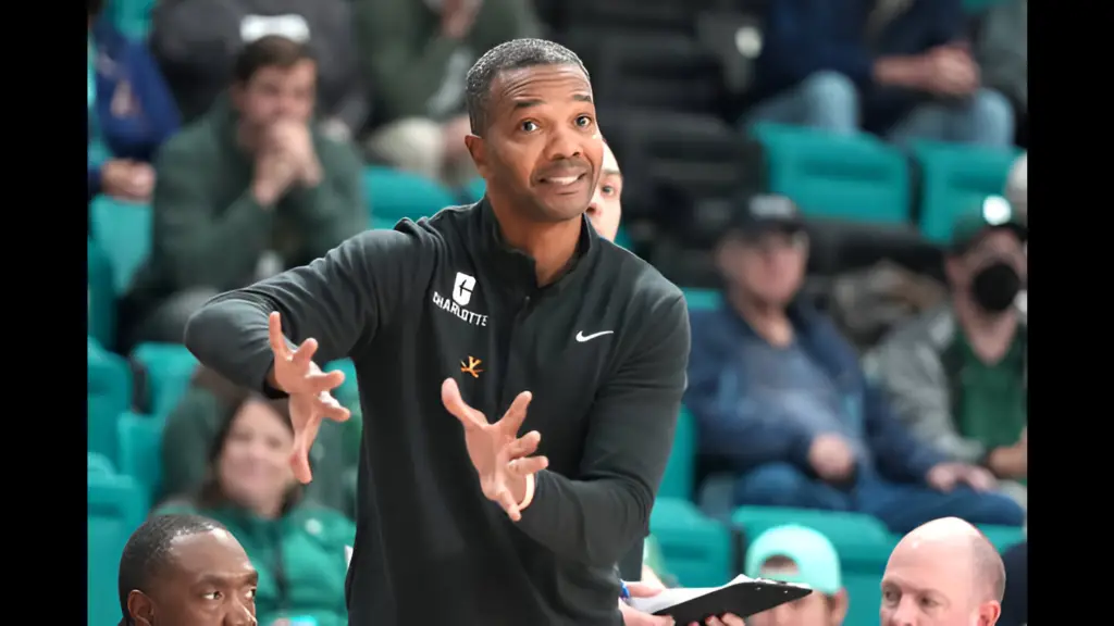 Former Charlotte 49ers head coach Ron Sanchez signals to his players in the first half during a second-round game of the Myrtle Beach Invitational college basketball game against the Tulsa Golden Hurricane