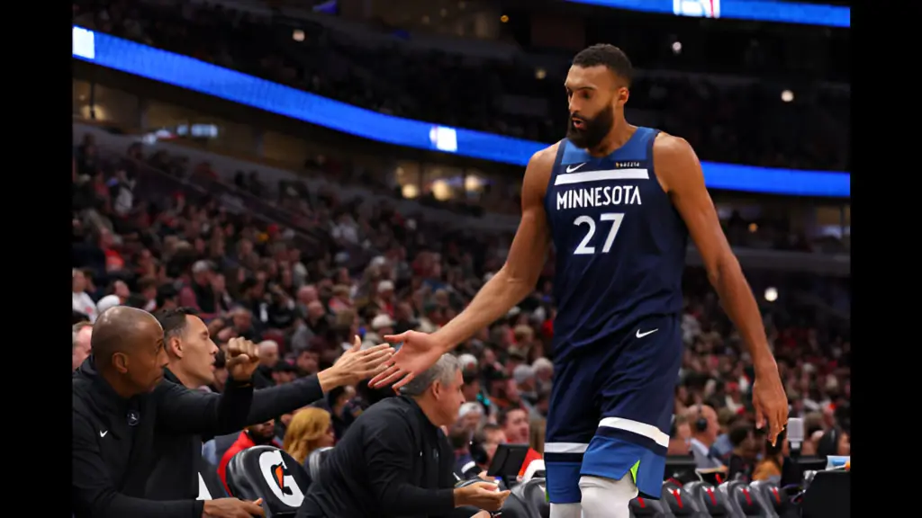 Minnesota Timberwolves center Rudy Gobert high-fives coaches on the bench against the Chicago Bulls during the second half of a preseason game