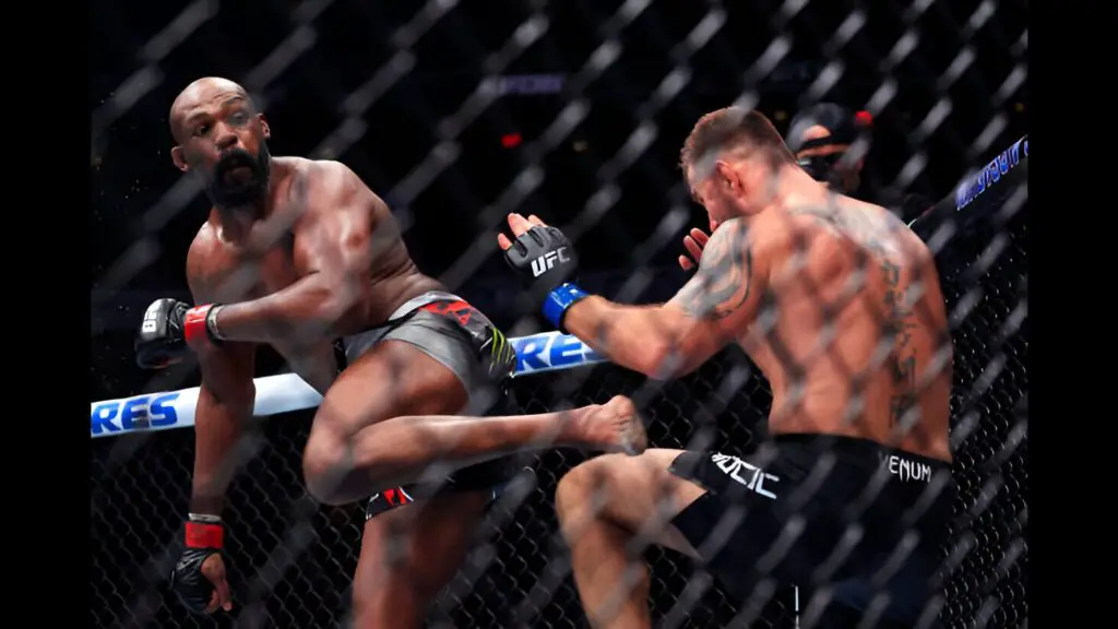 UFC Heavyweight Champion Jon Jones spinning back kicks challenger Stipe Miocic during their UFC 309 heavyweight title bout