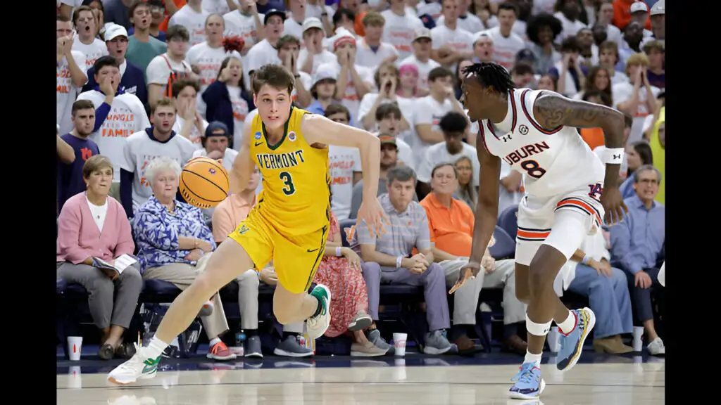 Auburn Tigers player JaHeim Hudson defends against Vermont Catamounts player TJ Hurley, as he dribbles the ball towards the basket during the first half 